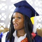 CASS graduate in blue academic gown